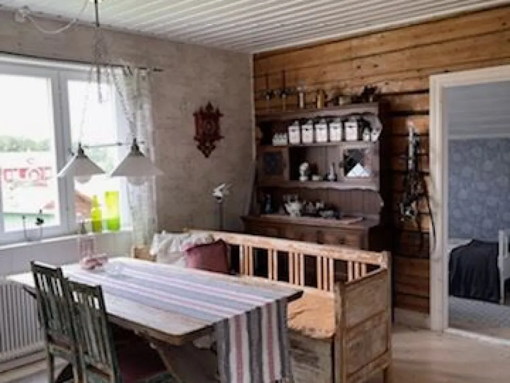 Wooden  sofa in the kitchen with a rustic table  with a woven cloth on. 